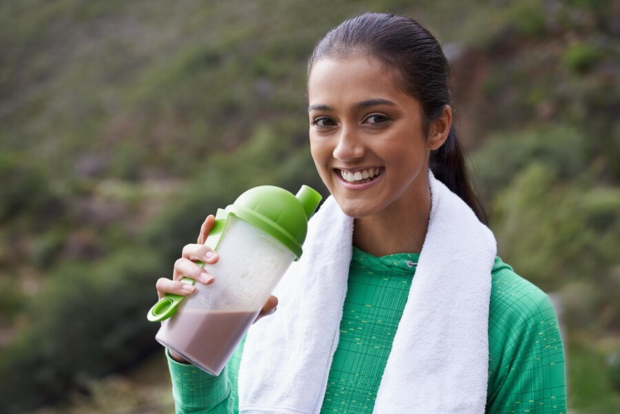 sports-drink-portrait-woman-with-protein-shake-bottle-health-wellness-energy-benefits-exercise-outdoor-hiking-person-with-smoothie-nutrition-diet-after-workout_590464-278092 (1)